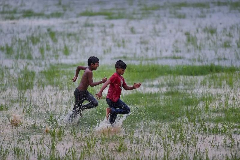  Children run in a waterlogged field after heavy monsoon rains in Ghaziabad, Wednesday, Aug. 19, 2020. (PTI Photo/Arun Sharma) 